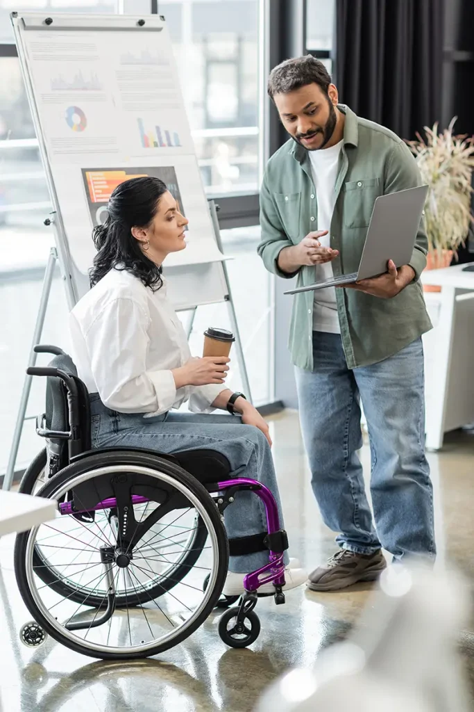 Two individuals consulting on data
